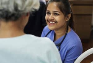 female nurse smiling at elder patient