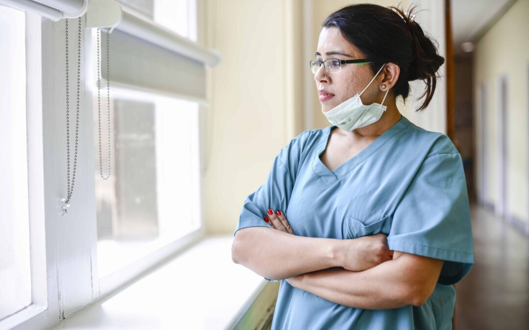 Female nurse staring out the window