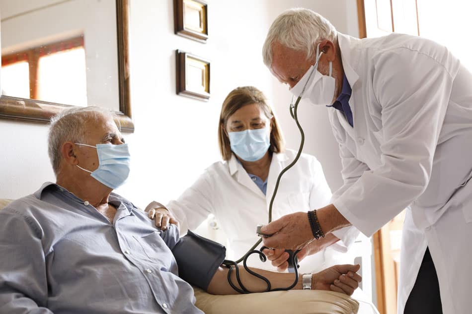 Two physicians caring for an elderly patient